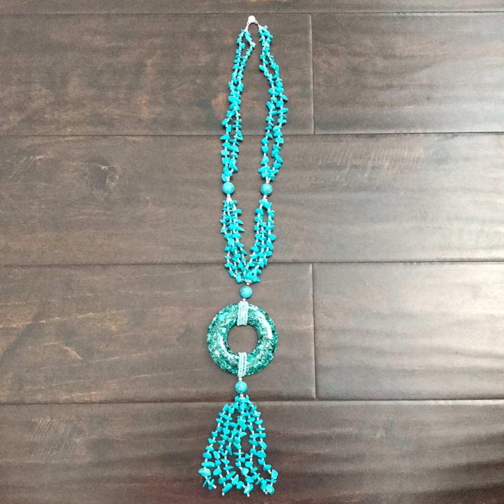 Teal necklace with large ring on bottom